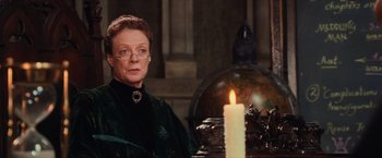 Movie still from “Harry Potter and the Sorcerer's Stone” (2001), directed by Chris Columbus – An older woman sitting in front of a lit candle; Close Up shot, Low angle