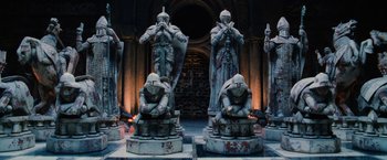 Movie still from “Harry Potter and the Sorcerer's Stone” (2001), directed by Chris Columbus – A group of statues that are sitting in the middle of a building; Wide shot, High angle