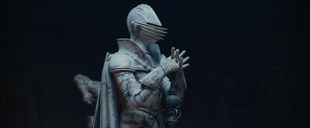 Movie still from “Harry Potter and the Sorcerer's Stone” (2001), directed by Chris Columbus – A statue of a man in a suit of armor; Medium shot, Low angle