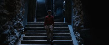 Movie still from “Harry Potter and the Sorcerer's Stone” (2001), directed by Chris Columbus – A man standing on a set of stairs in the dark; Wide shot, Low angle