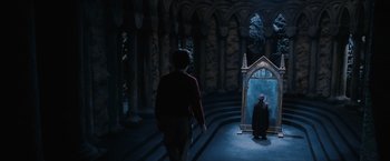 Movie still from “Harry Potter and the Sorcerer's Stone” (2001), directed by Chris Columbus – A man standing in front of a mirror in a room; Wide shot, High angle
