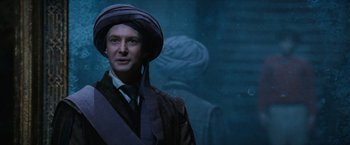 Movie still from “Harry Potter and the Sorcerer's Stone” (2001), directed by Chris Columbus – A man wearing a hat standing in front of a wall; Close Up shot, Over the shoulder angle