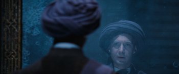 Movie still from “Harry Potter and the Sorcerer's Stone” (2001), directed by Chris Columbus – A man wearing a hat looking into a mirror; Close Up shot, Over the shoulder angle