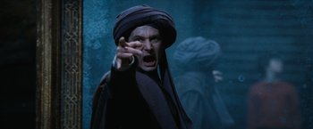 Movie still from “Harry Potter and the Sorcerer's Stone” (2001), directed by Chris Columbus – A man with a turban on pointing at something; Medium shot, Over the shoulder angle