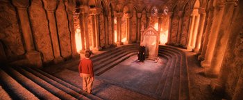 Movie still from “Harry Potter and the Sorcerer's Stone” (2001), directed by Chris Columbus – A man standing in front of a large stone wall; Wide shot, High angle