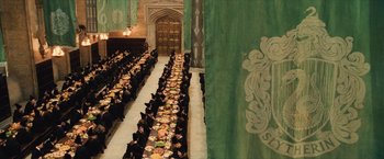 Movie still from “Harry Potter and the Sorcerer's Stone” (2001), directed by Chris Columbus – A large group of people sitting at a long table; Extreme Wide shot, High angle