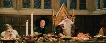 Movie still from “Harry Potter and the Sorcerer's Stone” (2001), directed by Chris Columbus – A woman and an old man sitting at a dinner table; Medium shot, High angle