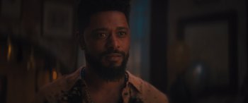 Movie still from “Haunted Mansion” (2023), directed by Justin Simien – A person with a beard looking at the camera; Close Up shot, Over the shoulder angle