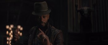 Movie still from “Haunted Mansion” (2023), directed by Justin Simien – A man in a hat and a leather jacket; Close Up shot, Over the shoulder angle