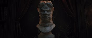 Movie still from “Haunted Mansion” (2023), directed by Justin Simien – A statue of a man with a turban on his head; Extreme Close Up shot, Low angle