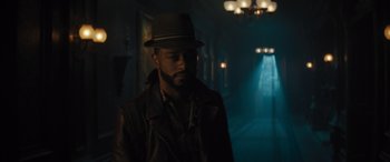 Movie still from “Haunted Mansion” (2023), directed by Justin Simien – A man wearing a hat standing in a dark room; Close Up shot, Low angle
