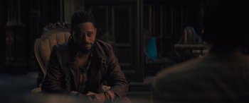 Movie still from “Haunted Mansion” (2023), directed by Justin Simien – A man sitting at a table in front of a mirror; Medium shot, Over the shoulder angle