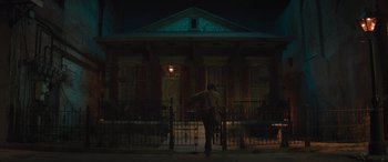 Movie still from “Haunted Mansion” (2023), directed by Justin Simien – A man standing in front of a building at night; Extreme Wide shot, Low angle