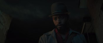 Movie still from “Haunted Mansion” (2023), directed by Justin Simien – A man wearing a hat and a jacket; Close Up shot, Low angle