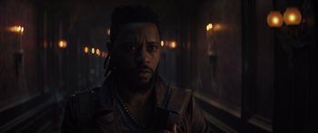 Movie still from “Haunted Mansion” (2023), directed by Justin Simien – A person wearing a leather jacket; Close Up shot, Low angle