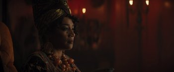 Movie still from “Haunted Mansion” (2023), directed by Justin Simien – A person wearing a necklace; Close Up shot, Over the shoulder angle