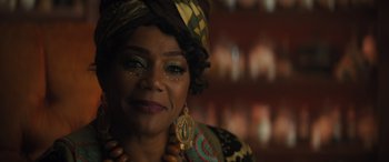 Movie still from “Haunted Mansion” (2023), directed by Justin Simien – A person wearing a head scarf; Close Up shot, Over the shoulder angle