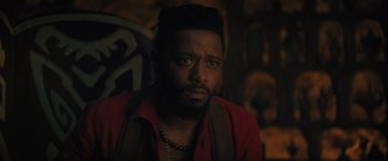 Movie still from “Haunted Mansion” (2023), directed by Justin Simien – A person wearing a red shirt; Close Up shot, Over the shoulder angle