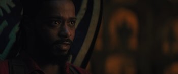 Movie still from “Haunted Mansion” (2023), directed by Justin Simien – A man's face in the dark; Close Up shot, Over the shoulder angle