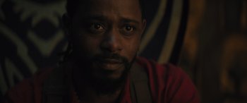 Movie still from “Haunted Mansion” (2023), directed by Justin Simien – A person wearing a red shirt; Close Up shot, Low angle