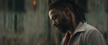 Movie still from “Haunted Mansion” (2023), directed by Justin Simien – A person with dreadlocks; Close Up shot, Low angle