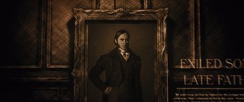 Movie still from “Haunted Mansion” (2023), directed by Justin Simien – A man standing in front of a painting of himself; Close Up shot, Low angle