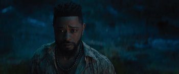 Movie still from “Haunted Mansion” (2023), directed by Justin Simien – A person wearing a necklace; Close Up shot, Over the shoulder angle