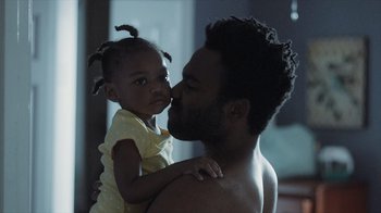 Movie still from “Atlanta” (2016), created by Donald Glover – A man and a little girl kissing each other; Close Up shot, Over the shoulder angle