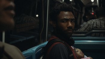 Movie still from “Atlanta” (2016), created by Donald Glover – A person riding a bus at night; Close Up shot, Over the shoulder angle