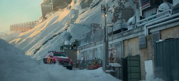 Movie still from “Heart of Stone” (2023), directed by Tom Harper – A car parked on the side of a road in the snow; Extreme Wide shot, Low angle