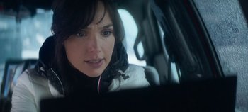 Movie still from “Heart of Stone” (2023), directed by Tom Harper – A person in a car; Close Up shot, Over the shoulder angle