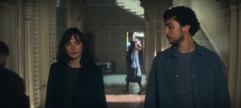 Movie still from “Heart of Stone” (2023), directed by Tom Harper – A man and a woman standing next to each other; Medium shot, Over the shoulder angle