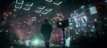 Movie still from “Heart of Stone” (2023), directed by Tom Harper – A man standing in front of a large screen; Extreme Wide shot, Over the shoulder angle