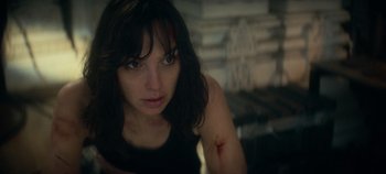 Movie still from “Heart of Stone” (2023), directed by Tom Harper – A person with a wound on her arm; Close Up shot, Over the shoulder angle