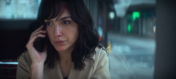 Movie still from “Heart of Stone” (2023), directed by Tom Harper – A person wearing a trench coat; Close Up shot, Over the shoulder angle