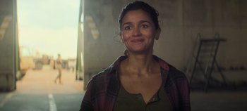 Movie still from “Heart of Stone” (2023), directed by Tom Harper – A person wearing a plaid shirt; Close Up shot, Over the shoulder angle