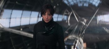 Movie still from “Heart of Stone” (2023), directed by Tom Harper – A woman in a black jacket standing in a tunnel; Close Up shot, Over the shoulder angle