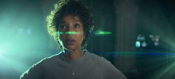 Movie still from “Heart of Stone” (2023), directed by Tom Harper – A person wearing a necklace; Close Up shot, Low angle