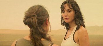 Movie still from “Heart of Stone” (2023), directed by Tom Harper – Two women standing next to each other in front of each other; Close Up shot, Over the shoulder angle