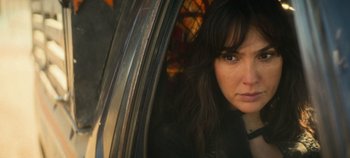Movie still from “Heart of Stone” (2023), directed by Tom Harper – A person sitting in a car; Close Up shot, Over the shoulder angle