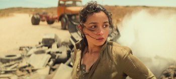Movie still from “Heart of Stone” (2023), directed by Tom Harper – A woman standing in front of a pile of rubble; Close Up shot, Low angle