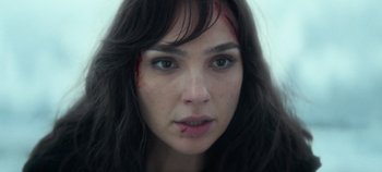 Movie still from “Heart of Stone” (2023), directed by Tom Harper – A person with a bruise on her face; Close Up shot, Over the shoulder angle