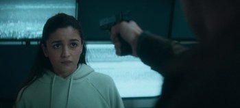 Movie still from “Heart of Stone” (2023), directed by Tom Harper – A man pointing a gun at a woman in front of a computer screen; Close Up shot, Over the shoulder angle