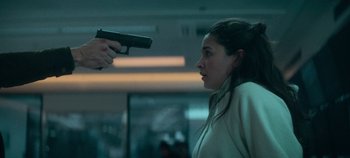 Movie still from “Heart of Stone” (2023), directed by Tom Harper – A woman holding a gun up to a man's face; Close Up shot, Over the shoulder angle