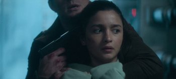 Movie still from “Heart of Stone” (2023), directed by Tom Harper – A man is holding a woman's hair while she looks at the camera; Close Up shot, Over the shoulder angle