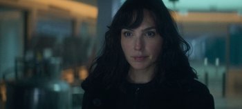 Movie still from “Heart of Stone” (2023), directed by Tom Harper – A person with long hair; Close Up shot, Over the shoulder angle