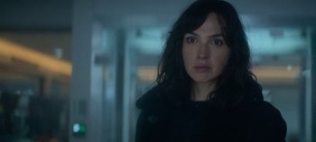 Movie still from “Heart of Stone” (2023), directed by Tom Harper – A person wearing a black jacket; Close Up shot, Over the shoulder angle