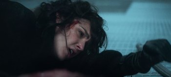 Movie still from “Heart of Stone” (2023), directed by Tom Harper – A person laying on the ground; Close Up shot, Overhead angle