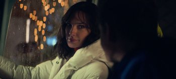 Movie still from “Heart of Stone” (2023), directed by Tom Harper – A person wearing a white jacket; Close Up shot, Over the shoulder angle