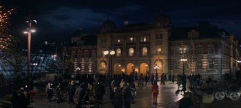 Movie still from “Heart of Stone” (2023), directed by Tom Harper – A group of people standing in front of a large building; Extreme Wide shot, High angle